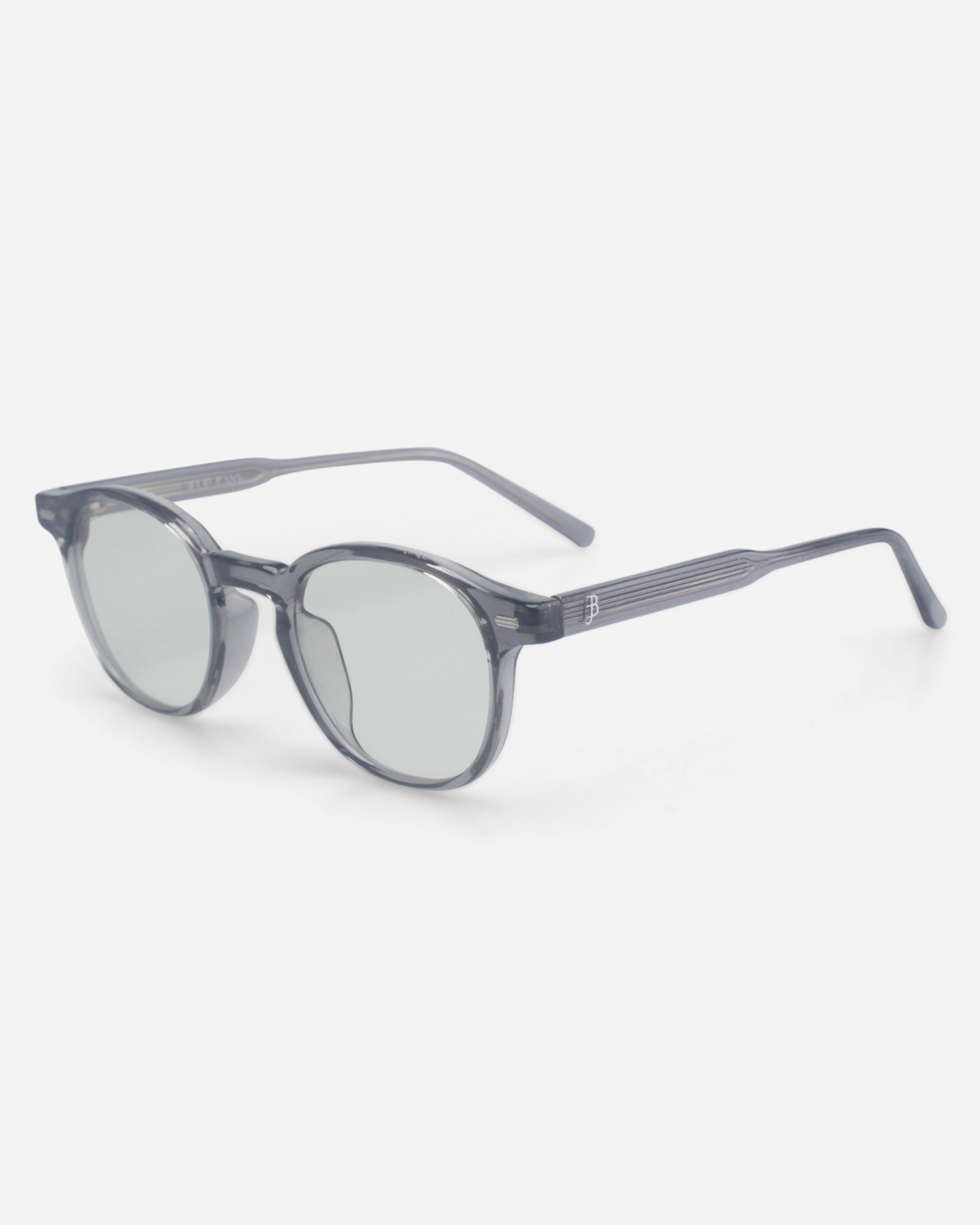 Gray sunglasses with round lenses on a plain background