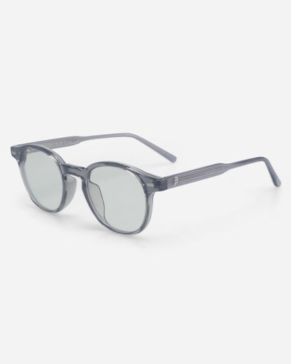 Gray sunglasses with round lenses on a plain background