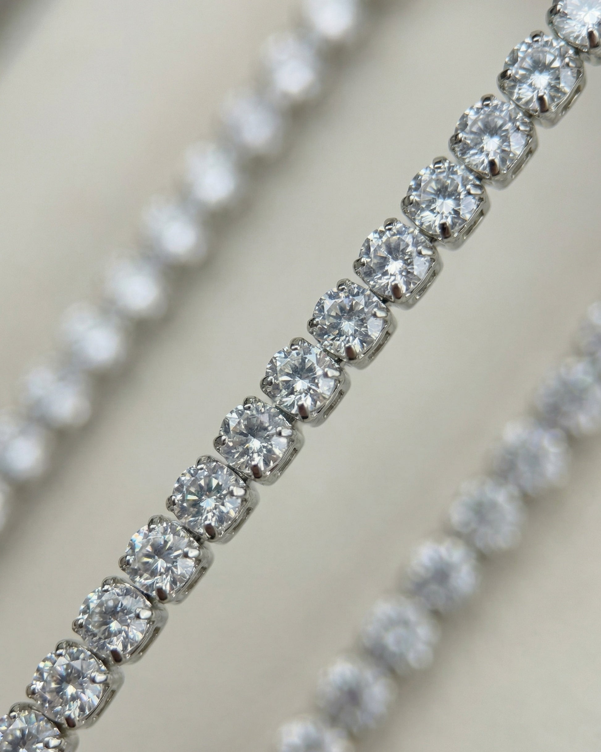 Close-up of multiple shiny diamond-like stones set in a row.