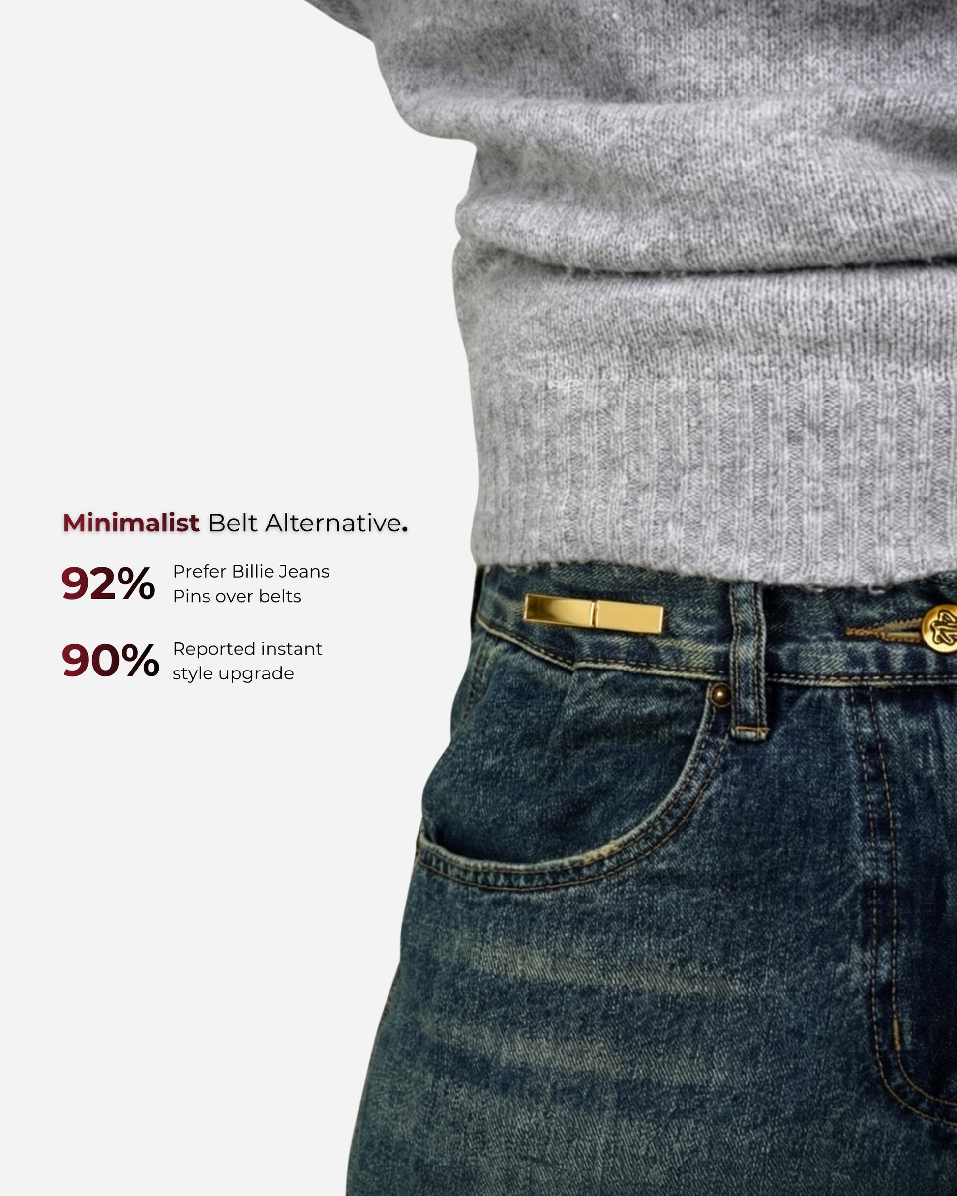 Close-up of a person wearing a gray sweater and blue jeans with a gold pin at the waist.