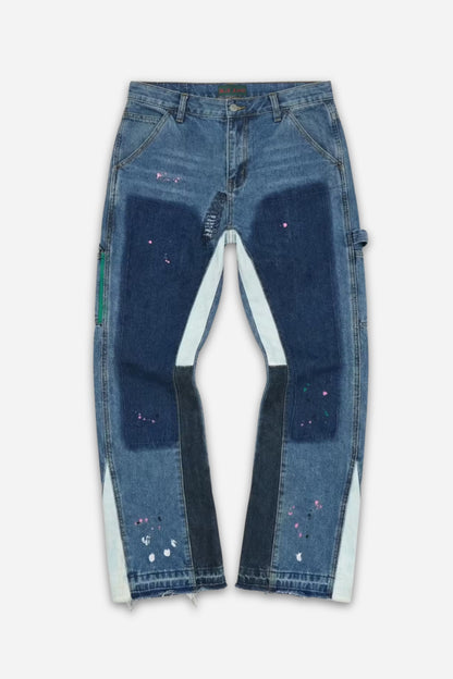 Medium-wash patchwork carpenter jeans with paint splatter and white gusset inserts by Billie Jeans