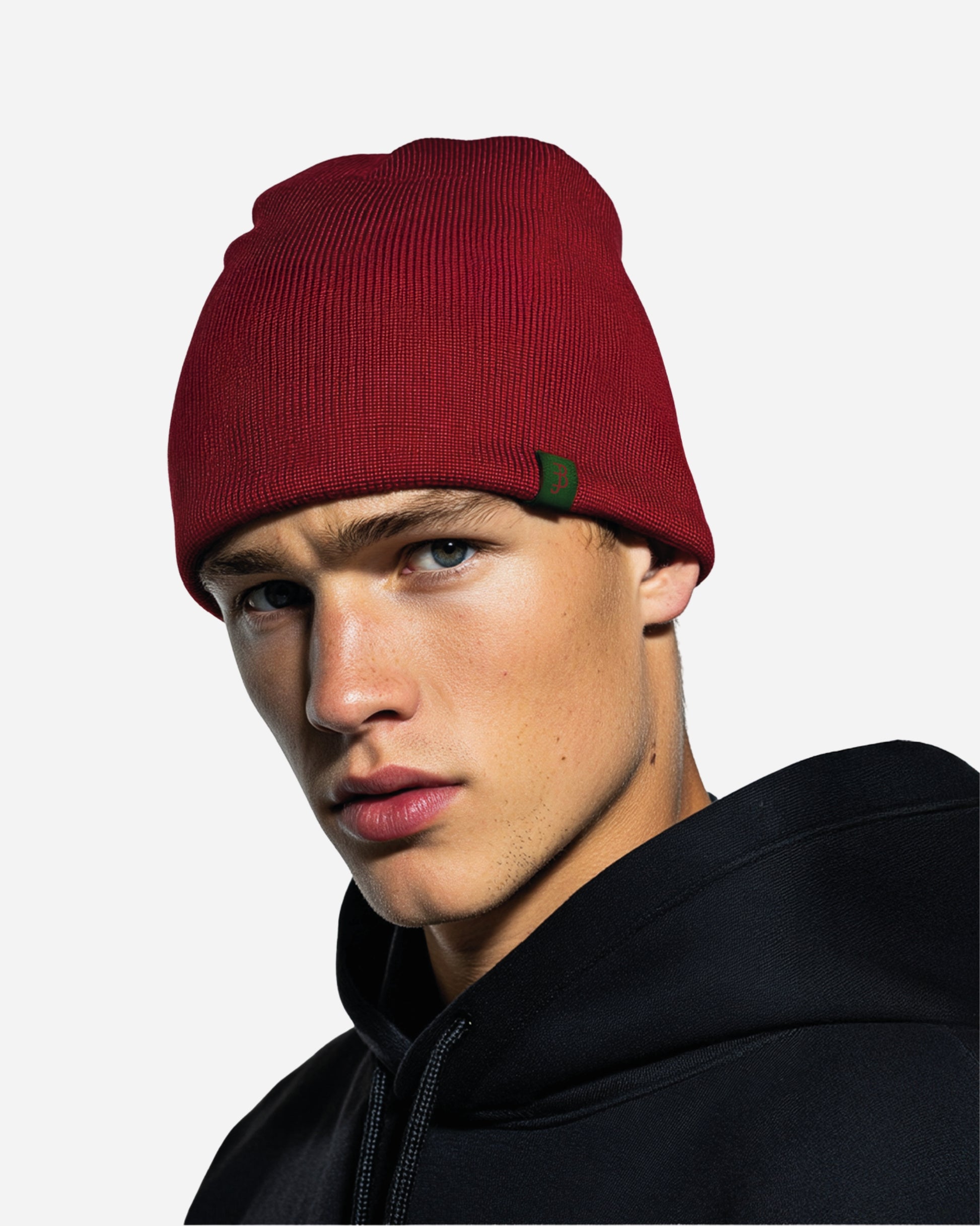 Close-up of a person wearing a red beanie and a black hoodie.