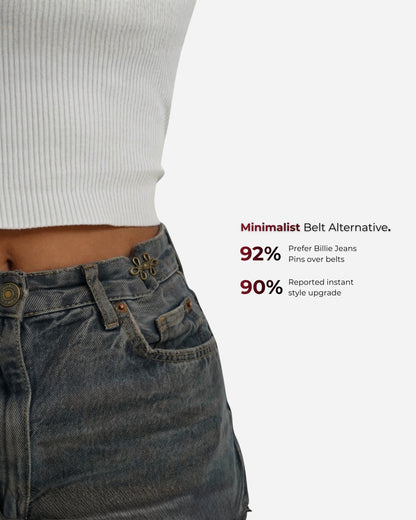 Close-up of a waist with a white ribbed top and denim jeans, featuring decorative buttons.