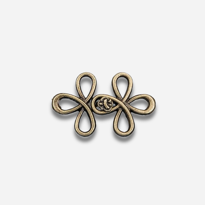 Antique gold sculpted waist knot on a light gray background