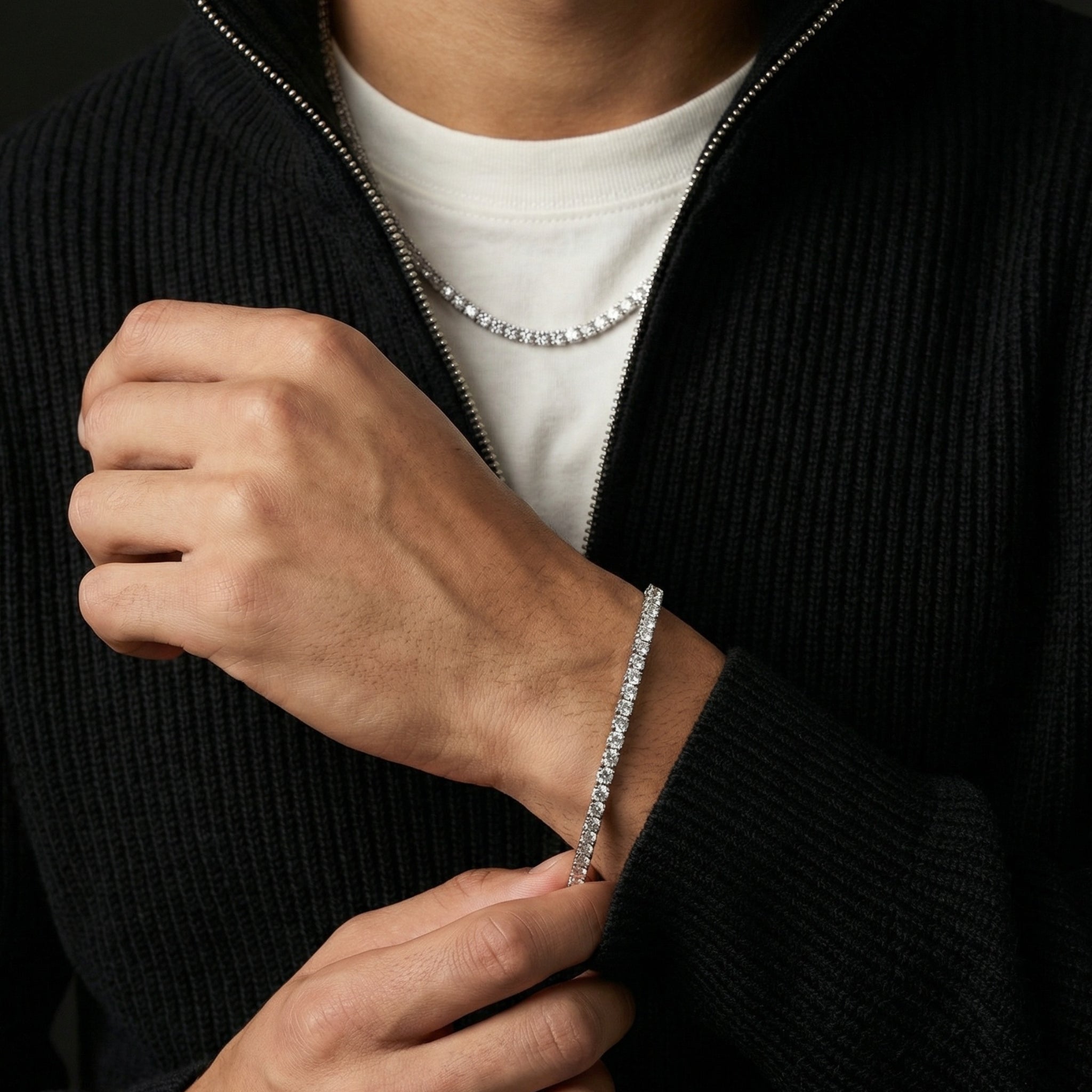 Man wearing dark sweater and jewelry set