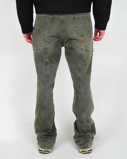 Back view of pants with visible stitching details, worn by a person with hands at their sides.