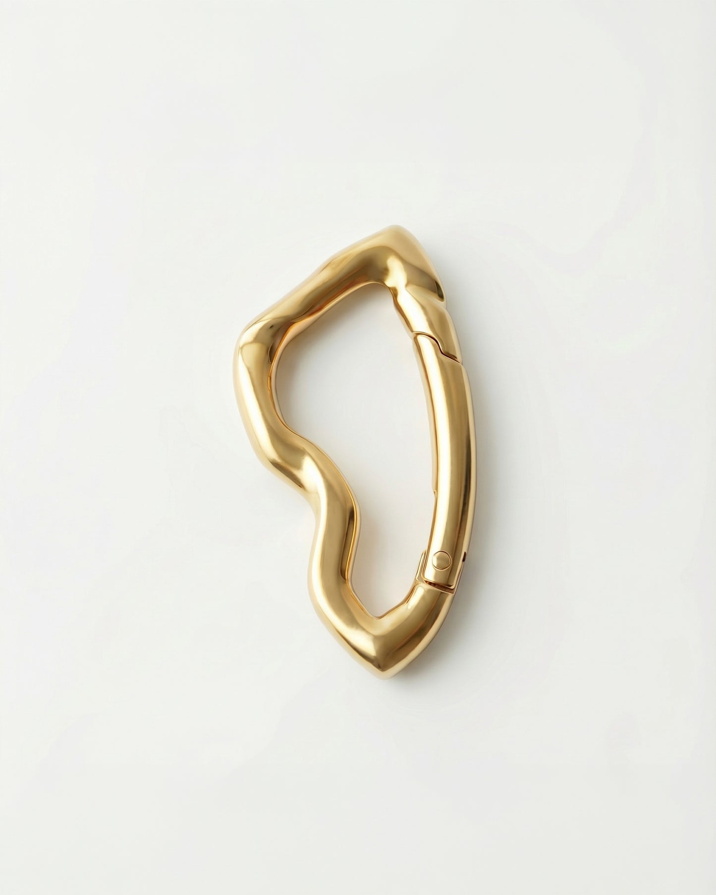 Gold abstract-shaped object on a plain white background