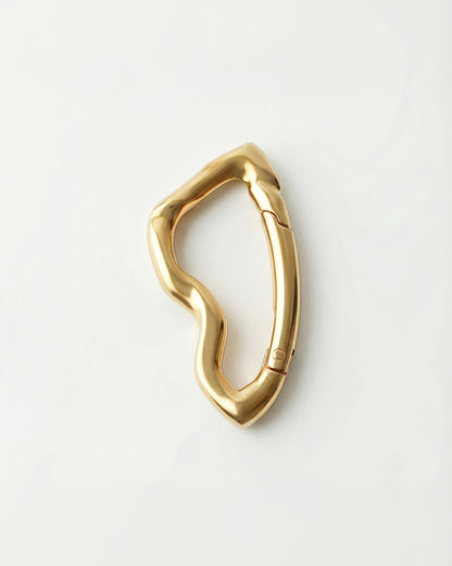 Gold abstract-shaped object on a plain white background