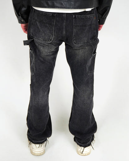 Person wearing black jeans and white sneakers, viewed from the back.