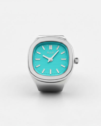 Billie Mono Ring Watch in silver with a turquoise dial, square finger watch on a light background