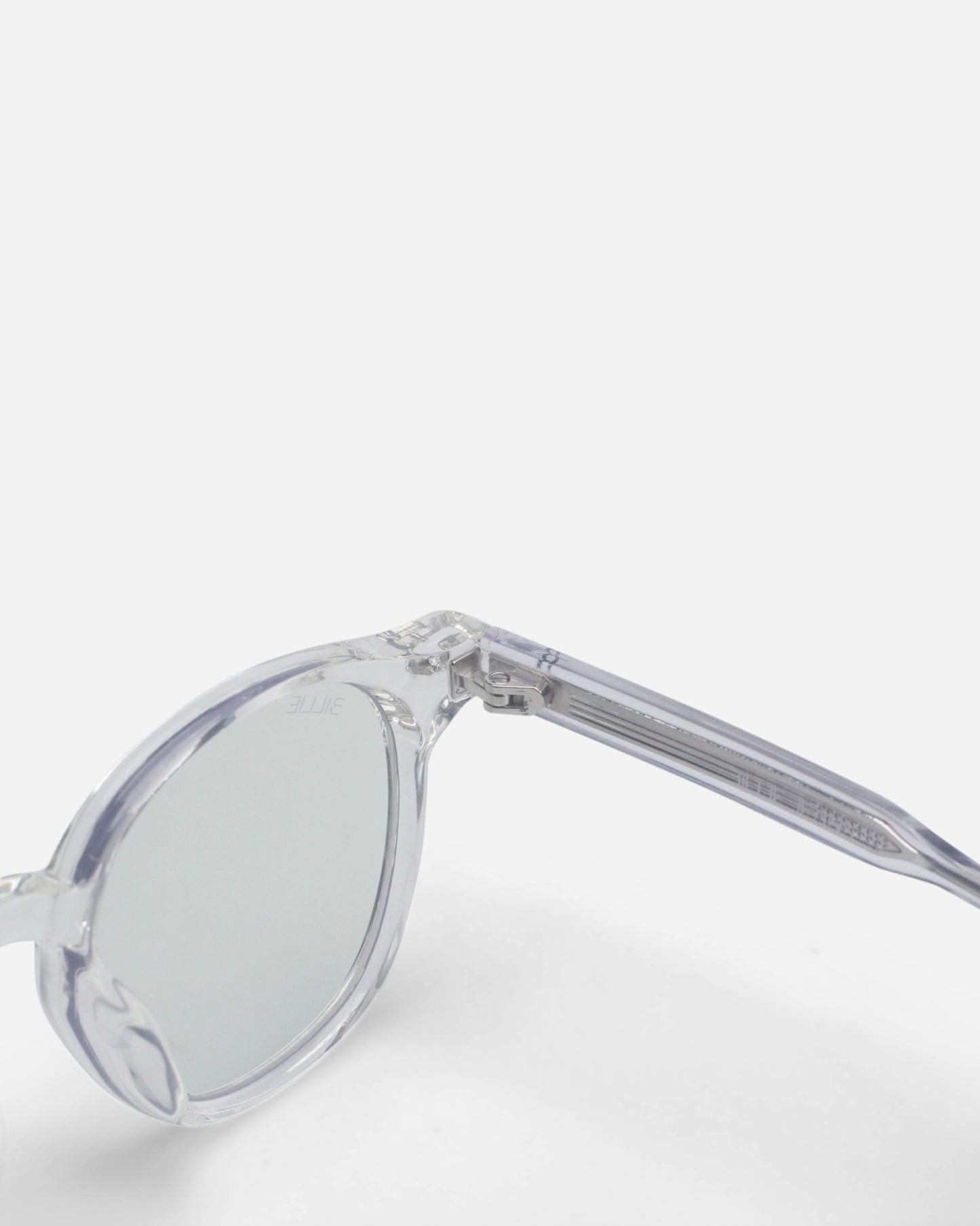 Close-up of clear sunglasses with round lenses and a transparent frame.