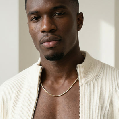 Man wearing a beige sweater with a neutral background