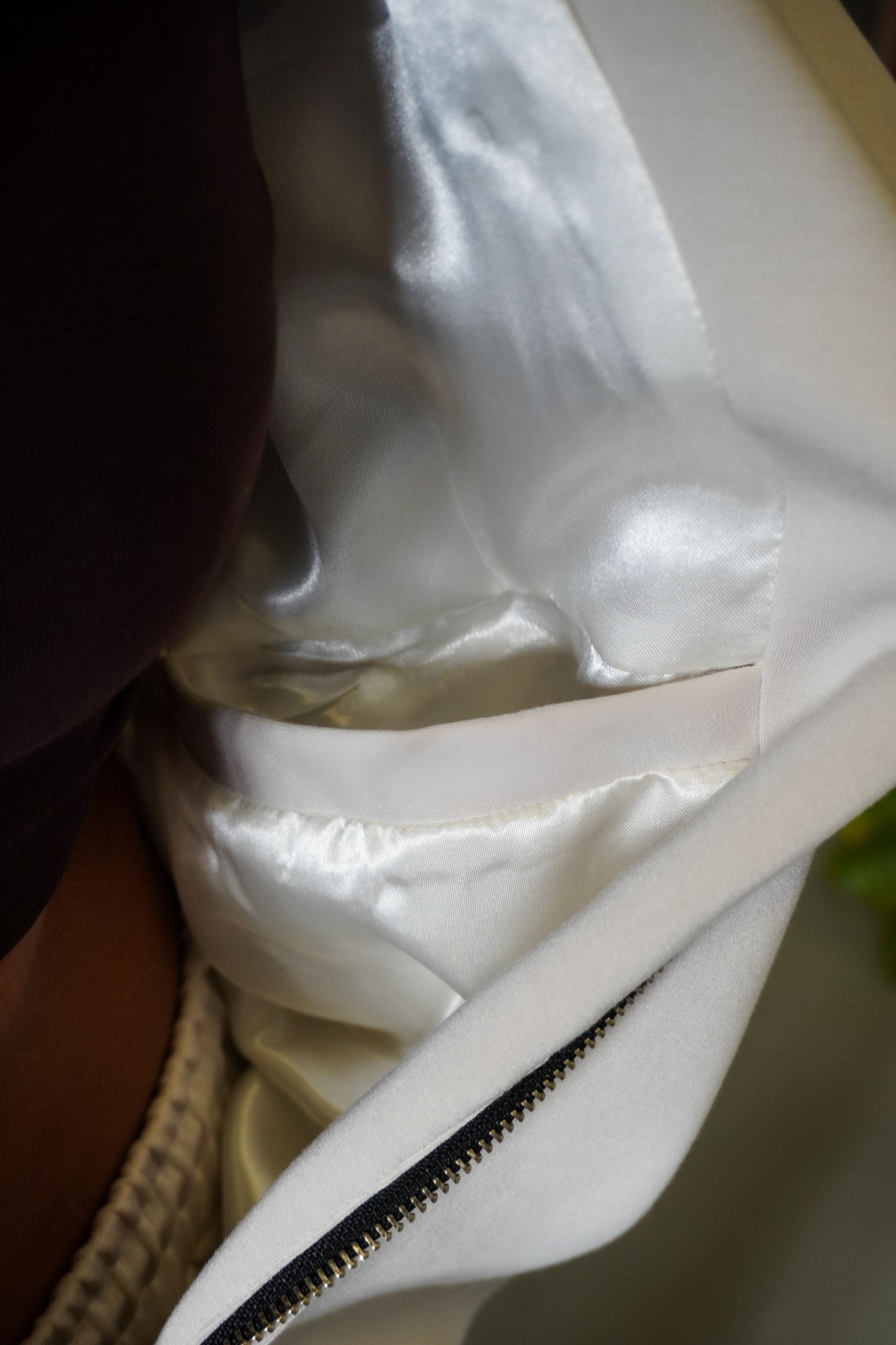 Close-up of a white garment with a zipper on a blurred background