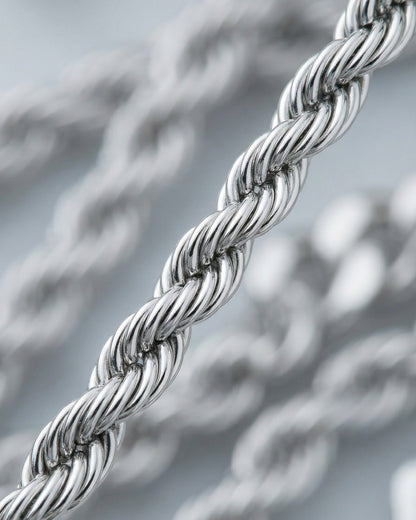 Close-up of a twisted silver chain with a shiny finish.