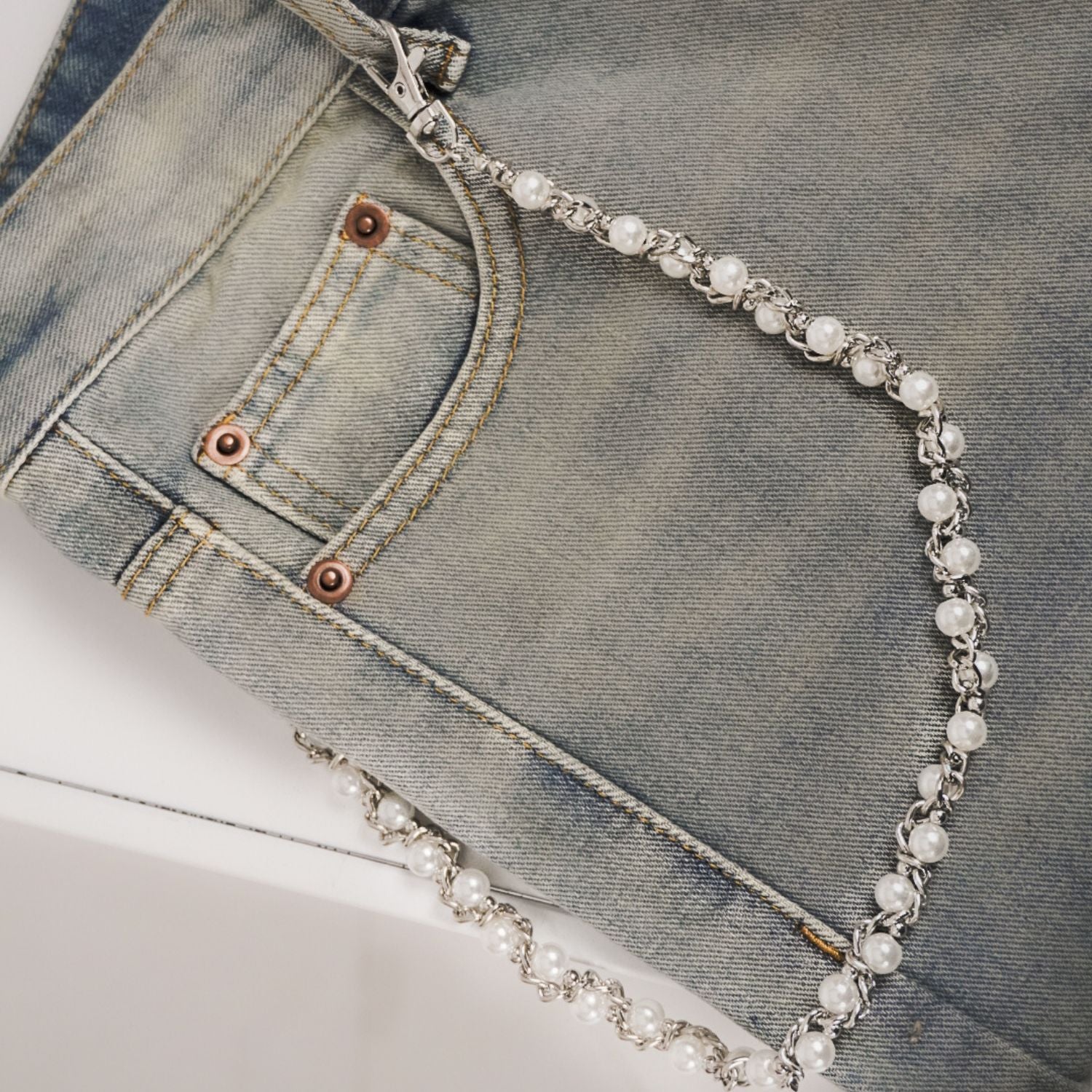 jeans chain draped over a pair of jeans
