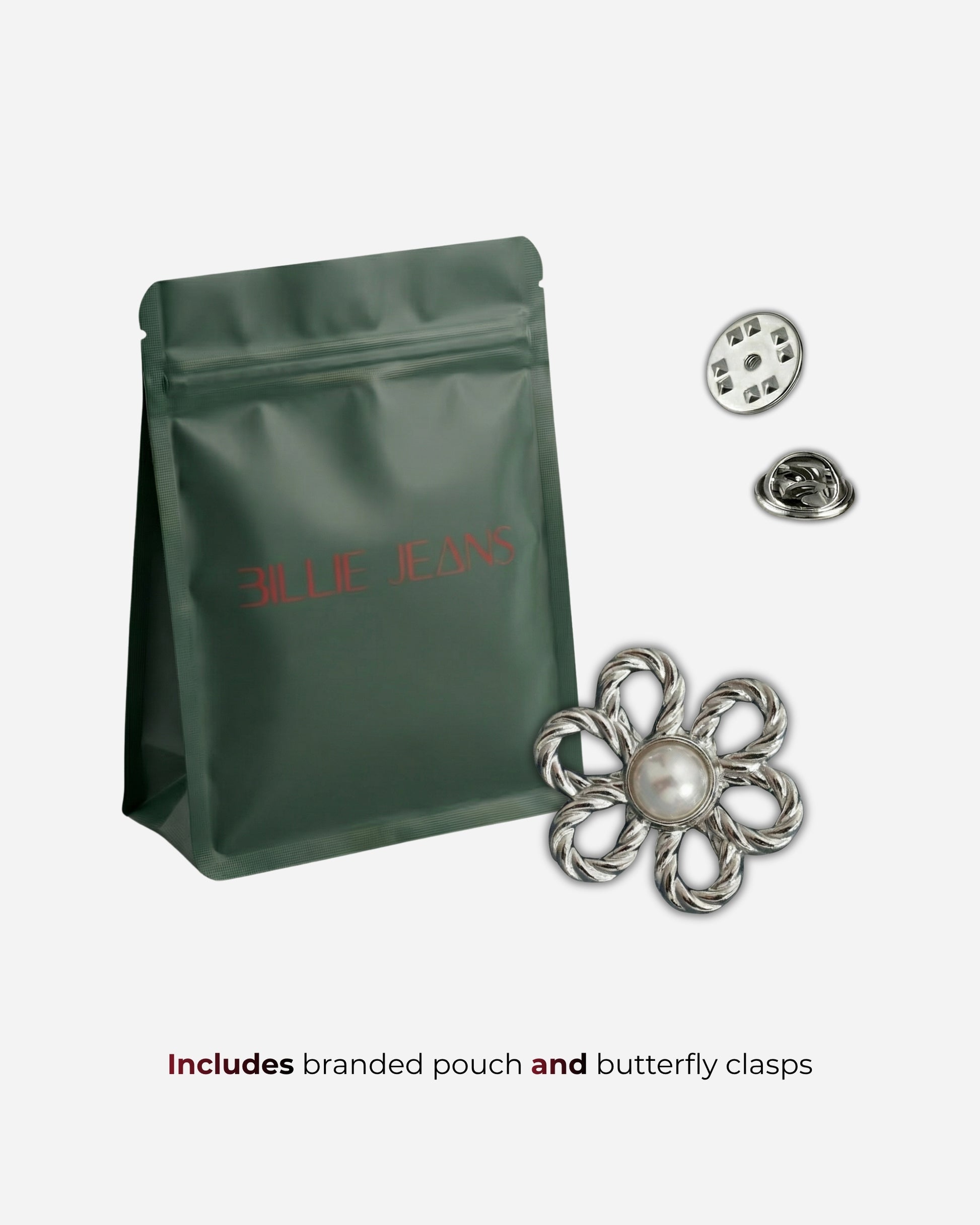 Green pouch with a flower brooch and two butterfly clasps on a plain background.