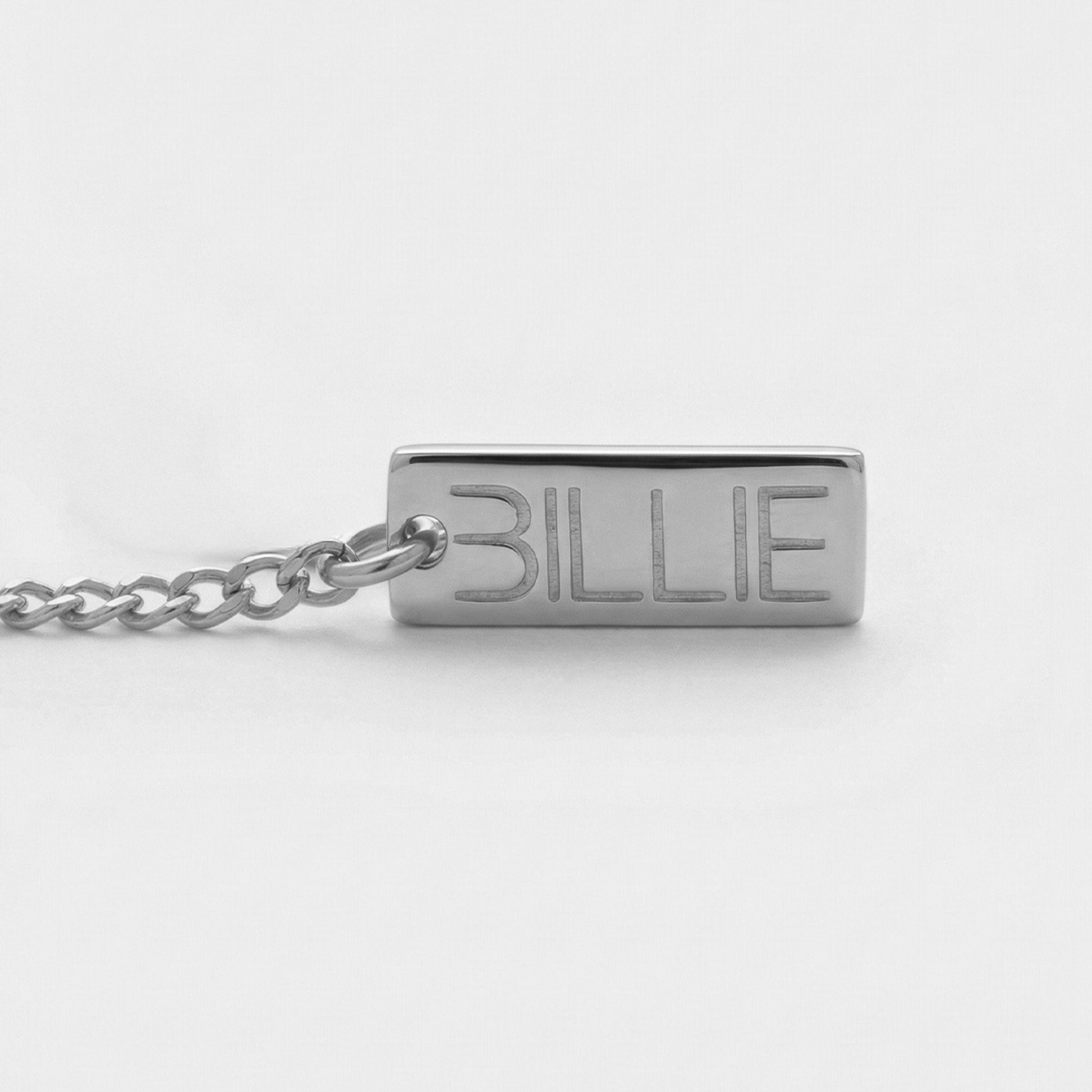 Silver necklace with 'BILLIE' pendant on a white background