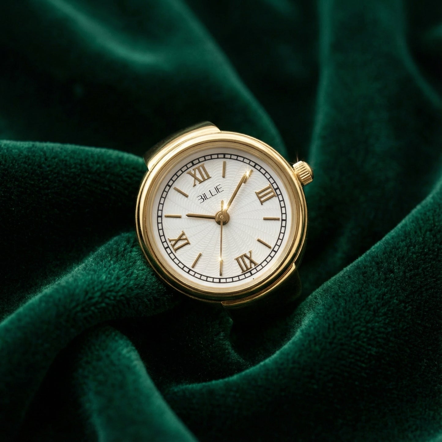 Gold watch with white face on a green fabric background