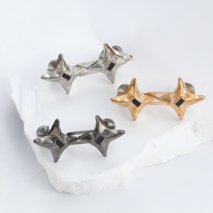 Three pairs of star-shaped waist knots in gold, silver, and black on a white background.