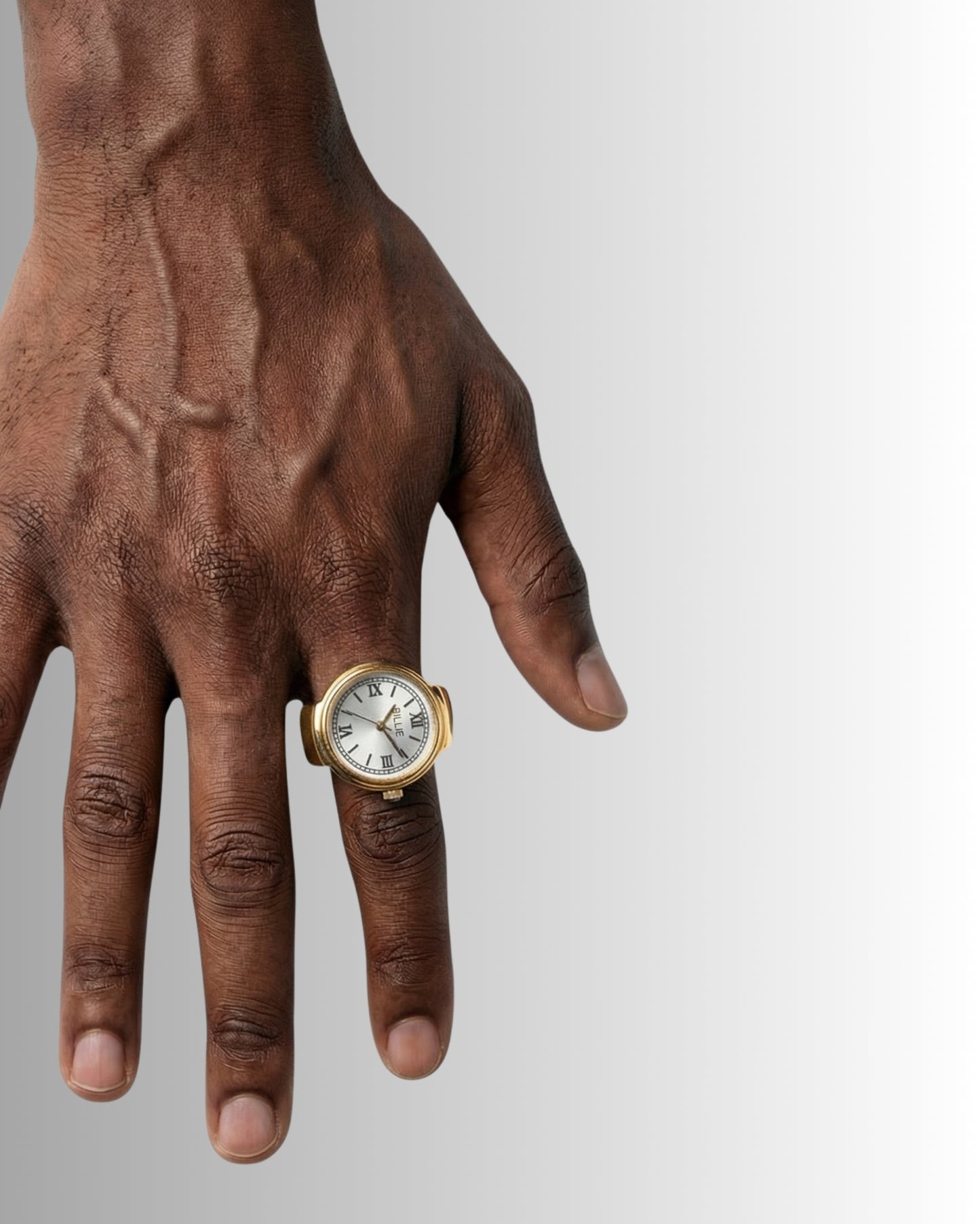Close-up of a hand wearing a gold ring and a watch with a white face.