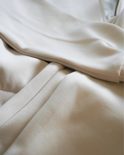 Close-up of folded light-colored fabric layers.