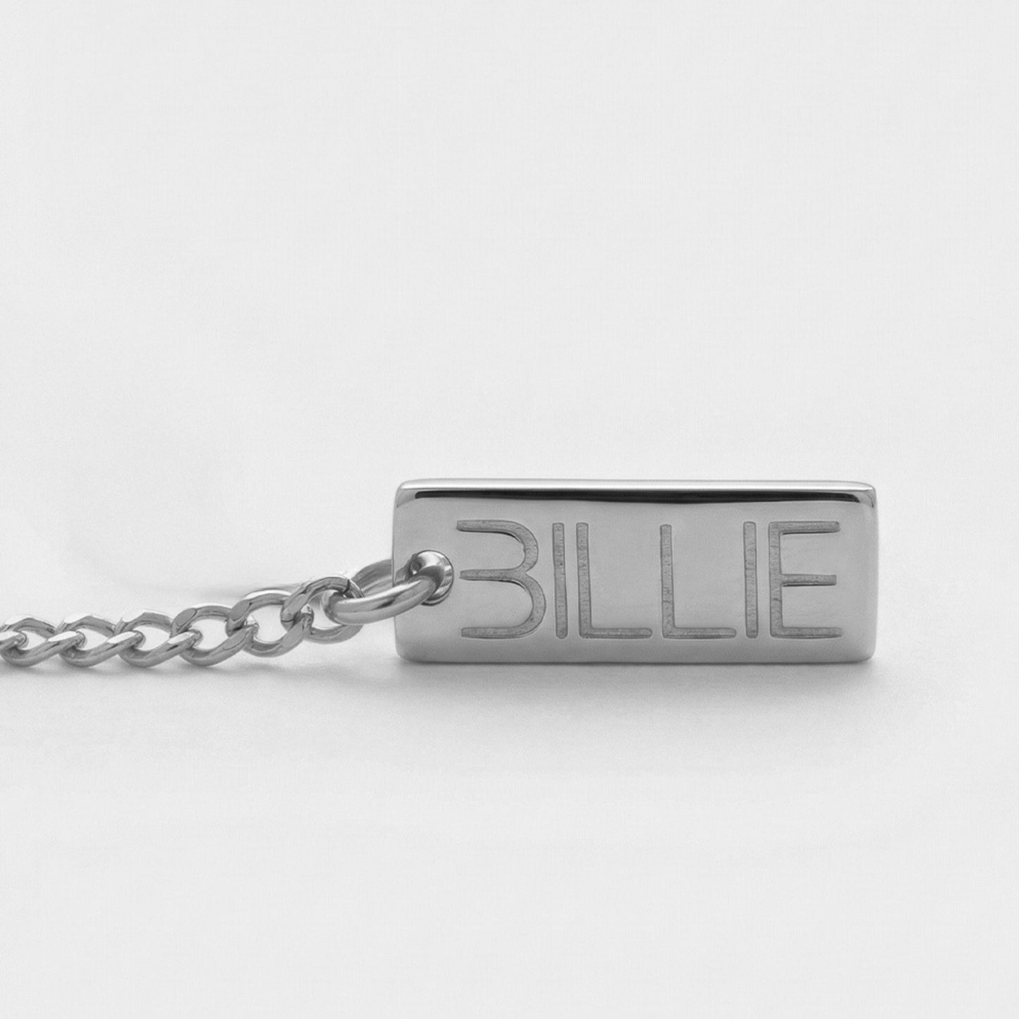 Silver chain with a rectangular tag engraved with 'BILLIE' on a white background