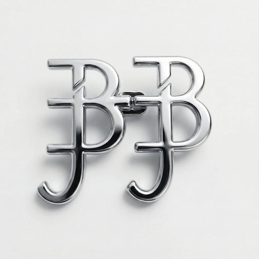 Silver brooch with a monogram design on a light gray background