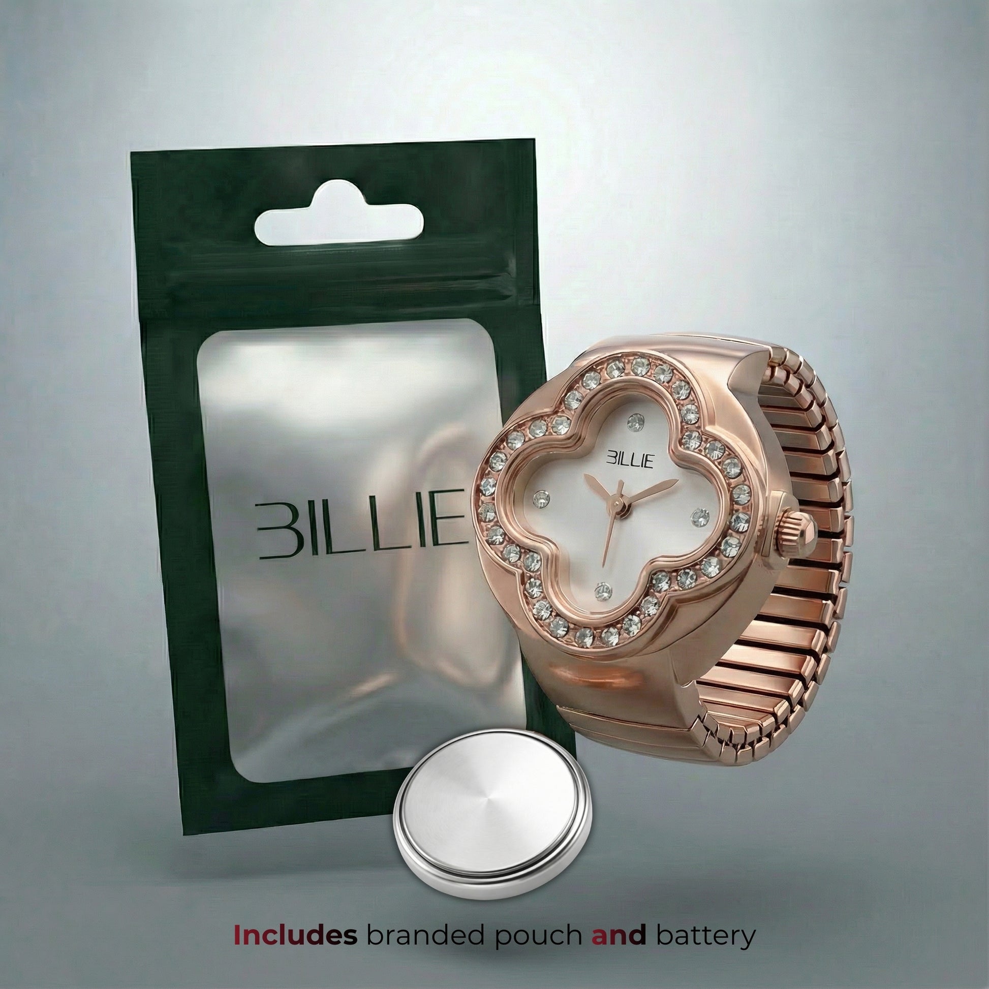 Rose gold watch with branded pouch and battery on a gray background