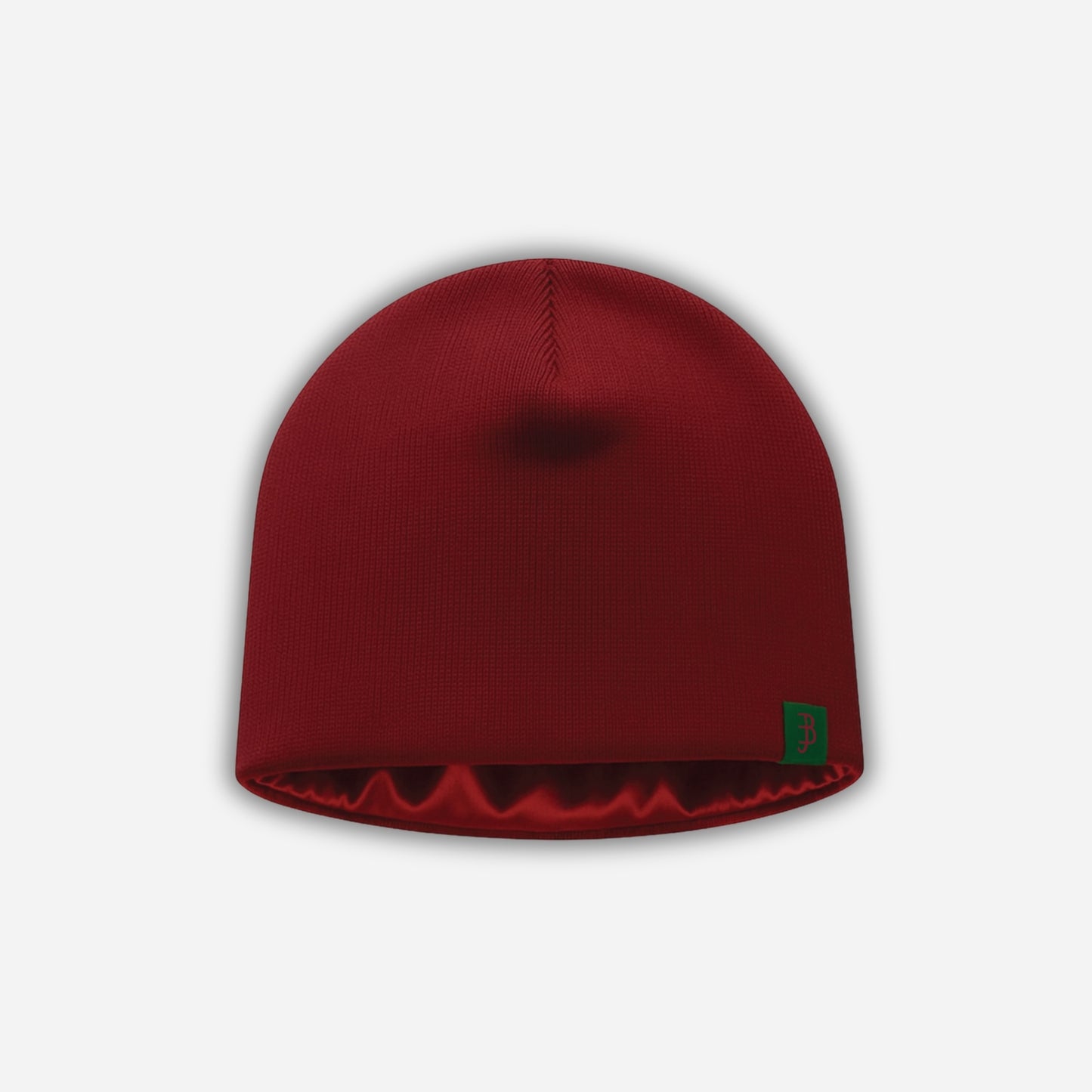 Red beanie with a green logo on a light gray background