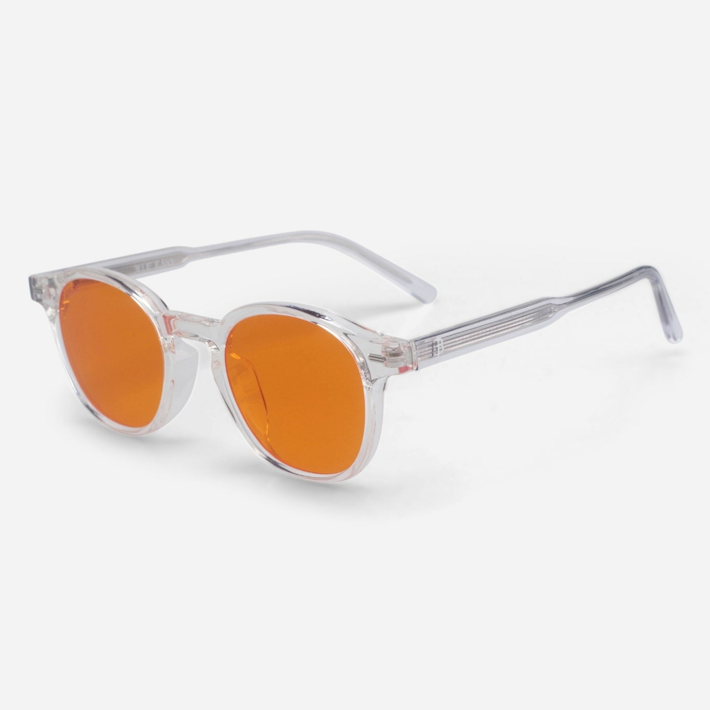 Sunglasses with orange lenses and clear frame on a white background