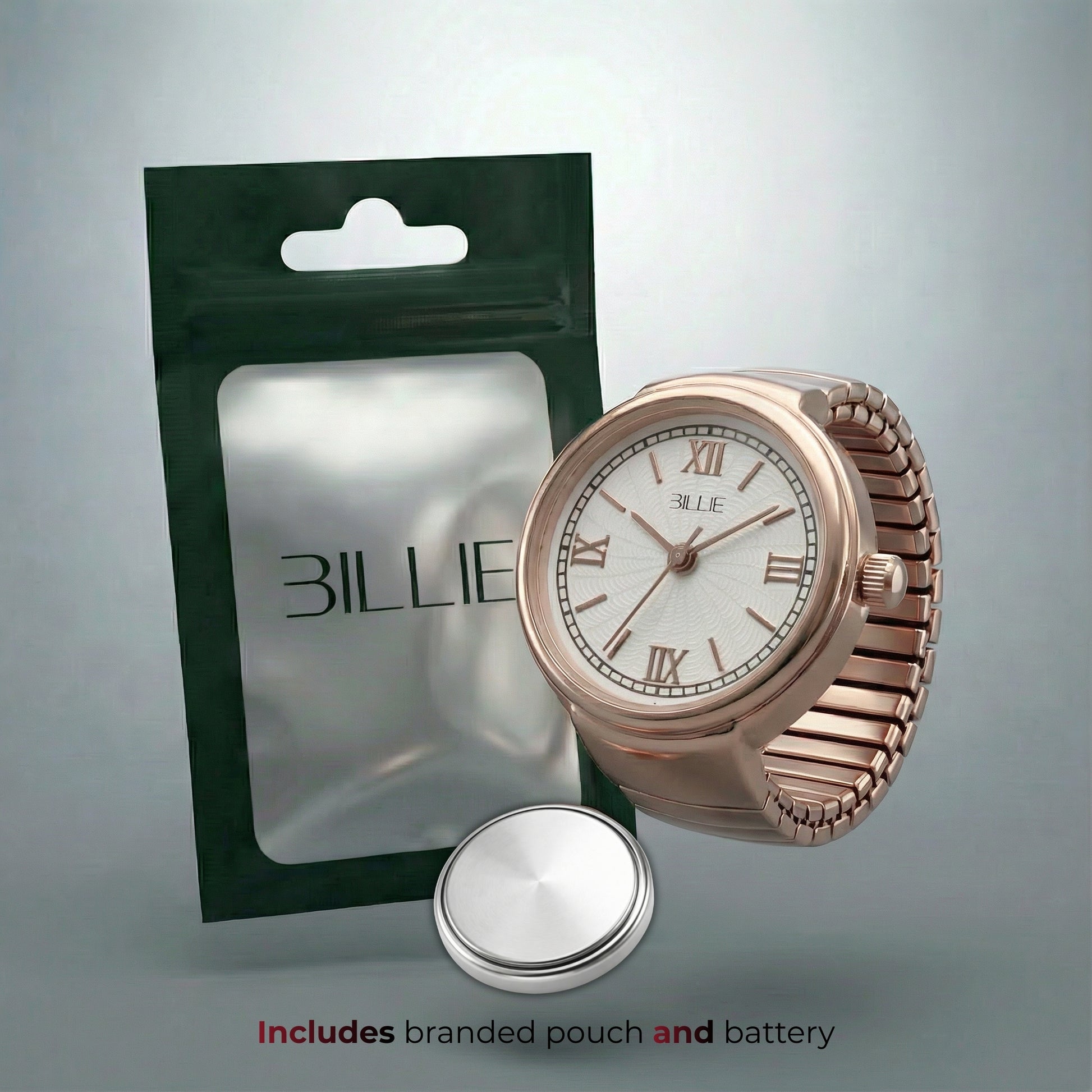 Rose gold watch with branded 'BILLIE' packaging on a gray background
