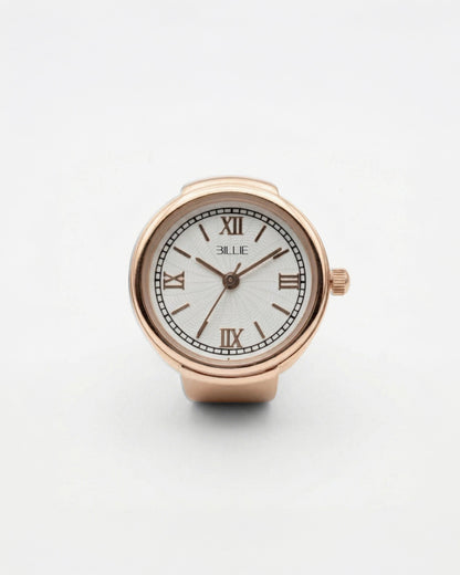 Billie Grace Ring Watch in rose gold, round finger watch with Roman numerals and white dial on a light background