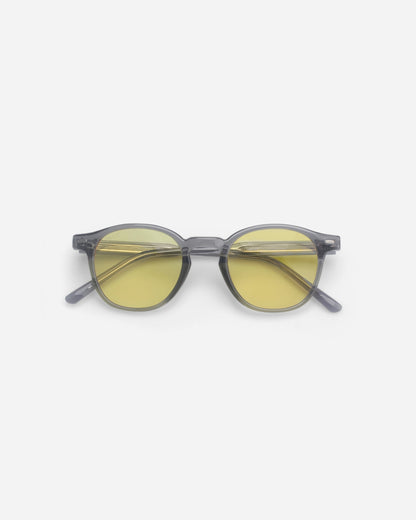 Round sunglasses with yellow lenses on a plain background