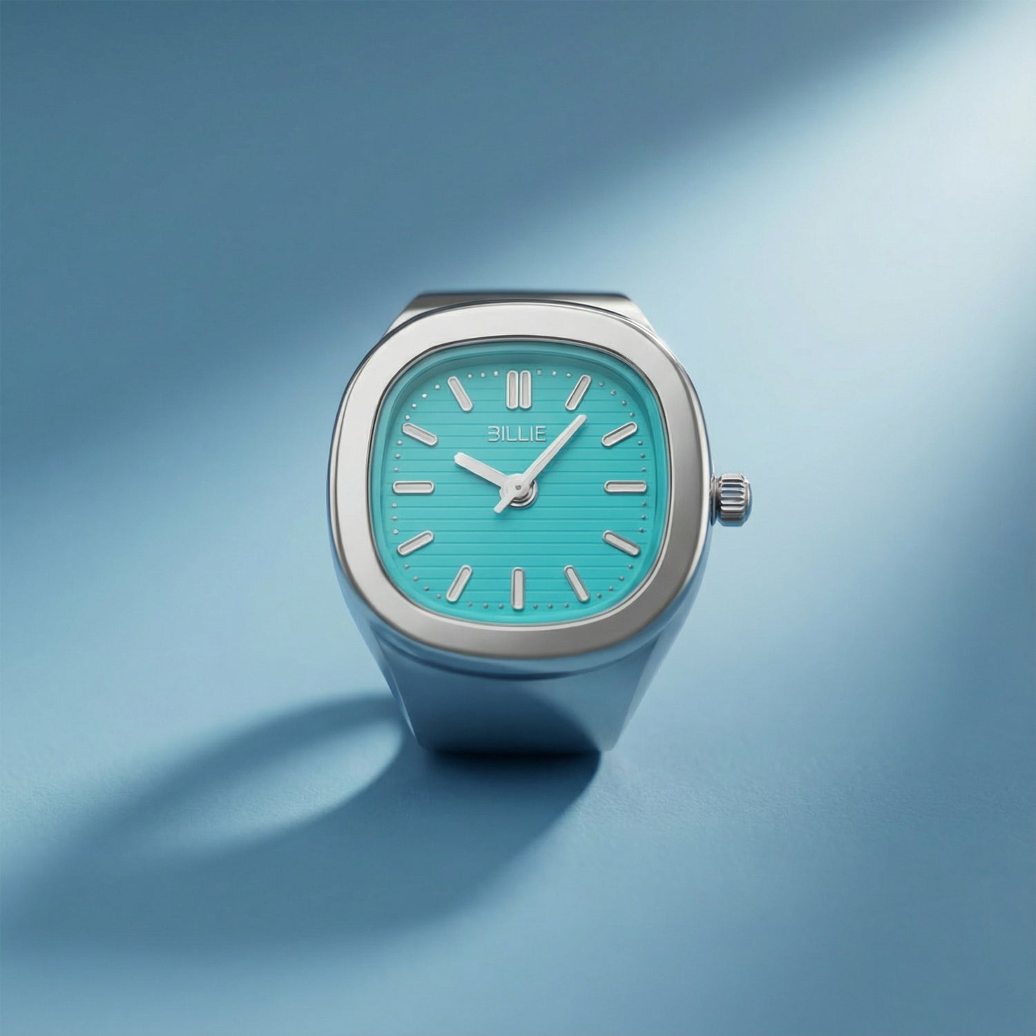 Wristwatch with turquoise dial and silver case on a gradient blue background