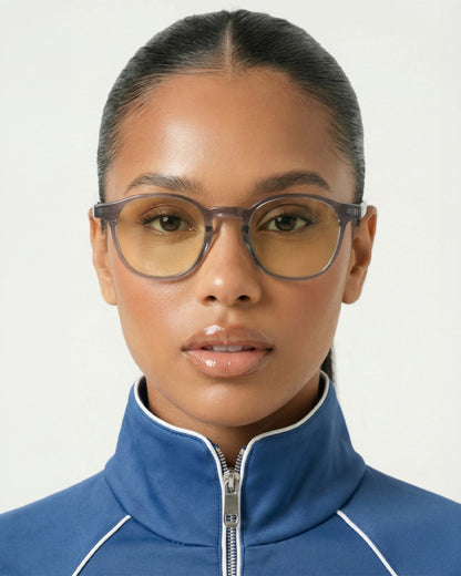 Woman wearing the Billie Blue Light Glasses in gray with yellow lenses, front view