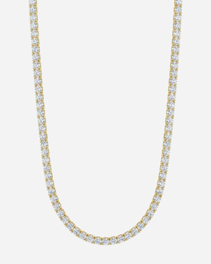 Gold chain necklace with clear stones on a plain white background