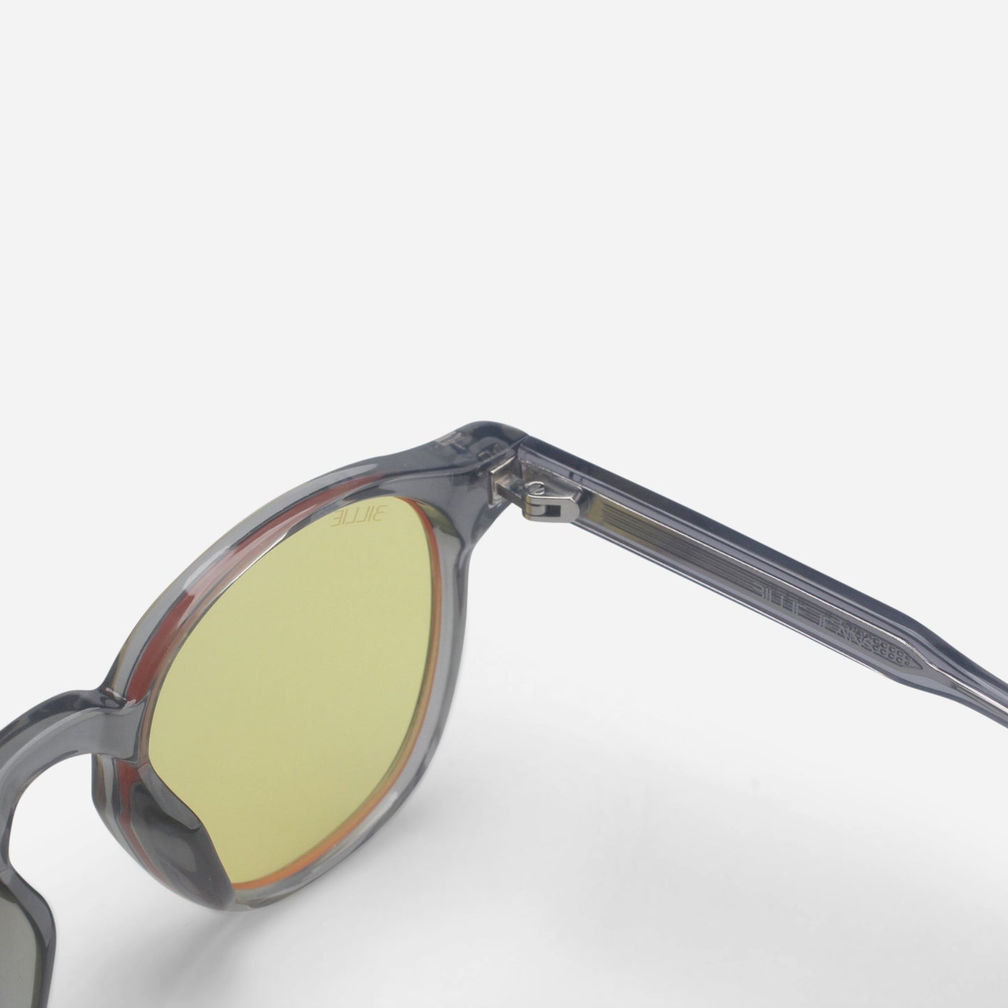 Blue light glasses with a clear frame and yellow-tinted lenses on a white background