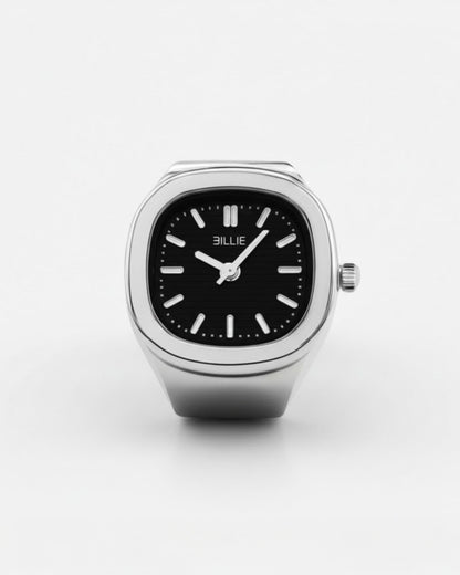 Silver watch with a black face and white hour markers on a plain background.