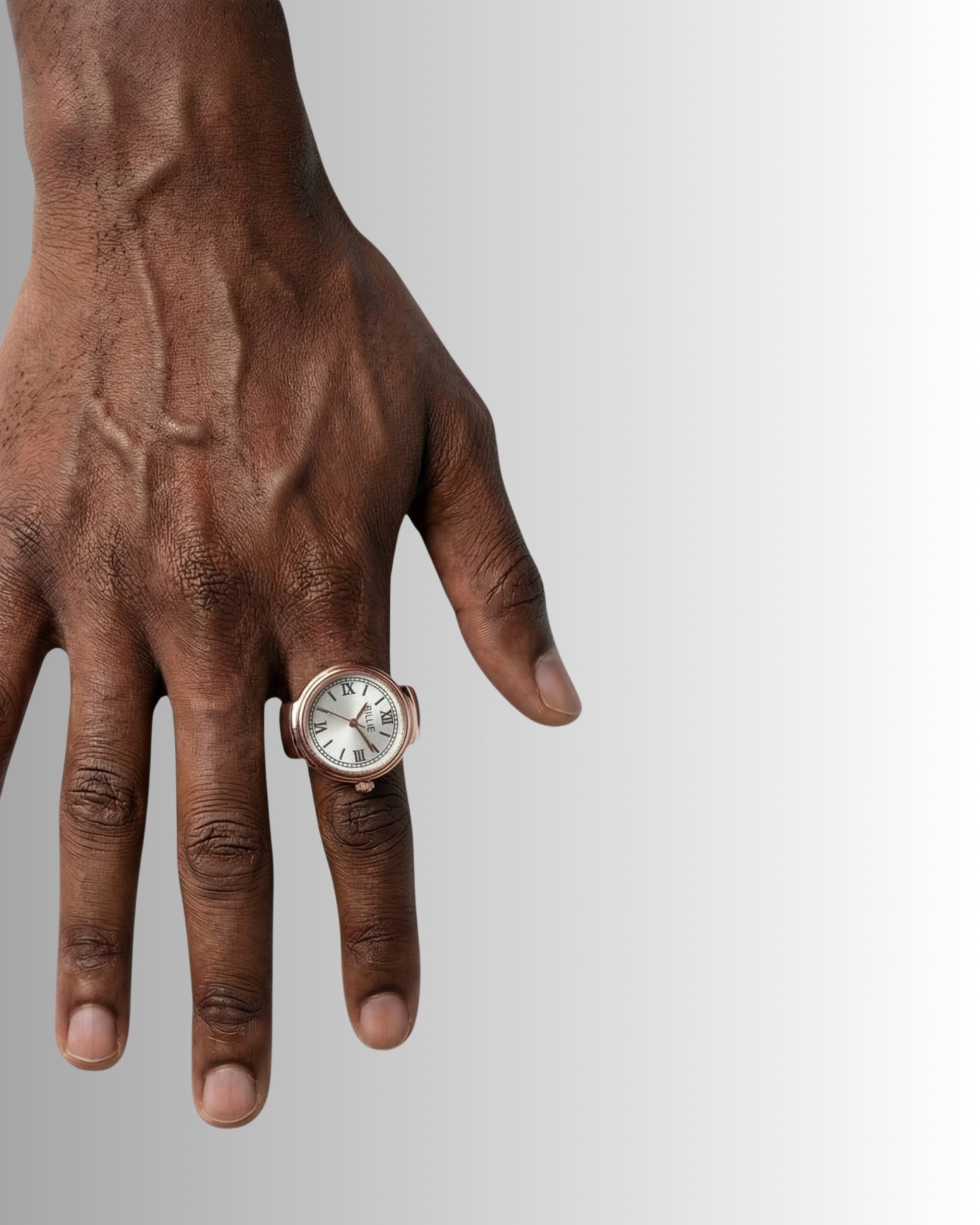 Close-up of a hand wearing a watch and a ring.
