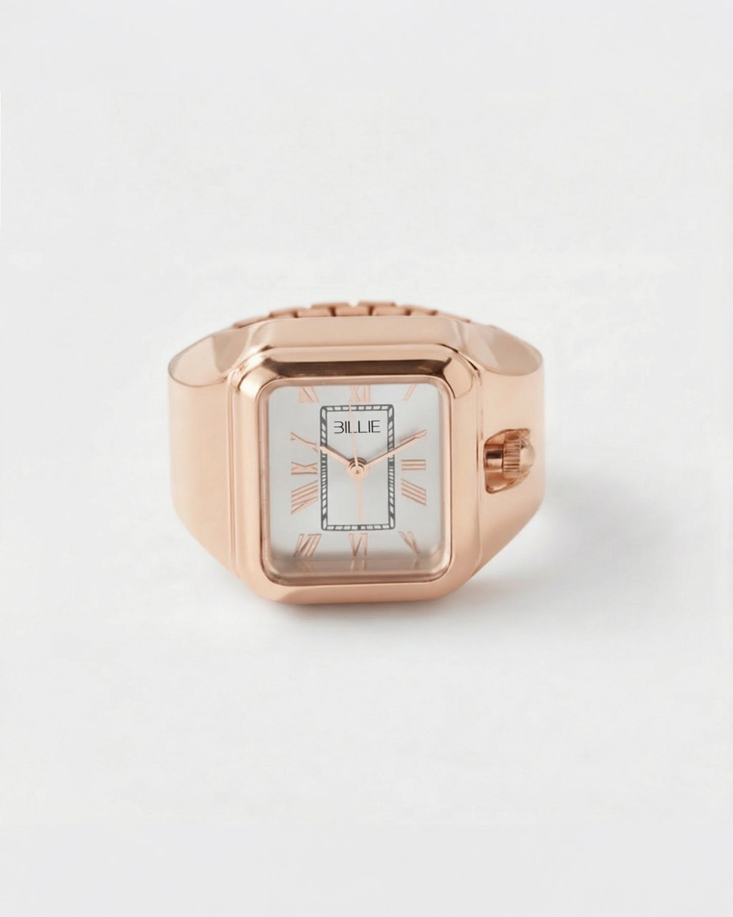 Rose gold watch with rectangular face and Roman numerals on a plain background.