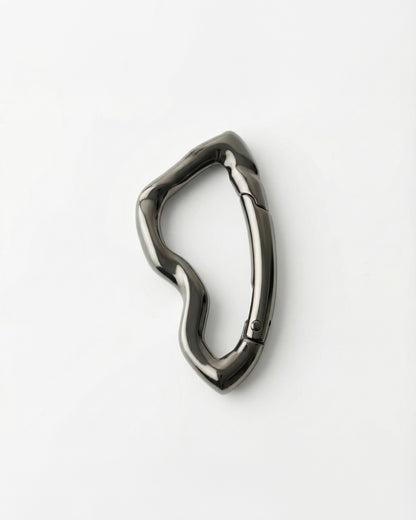 Abstract metallic clip on a plain white background