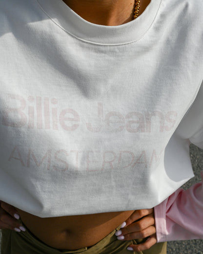 Close-up of a person wearing a white sweatshirt with text