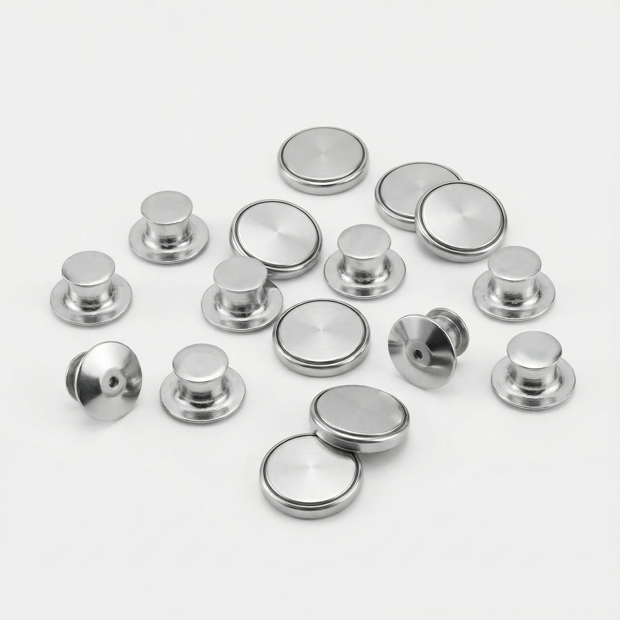 Collection of metallic buttons on a white background