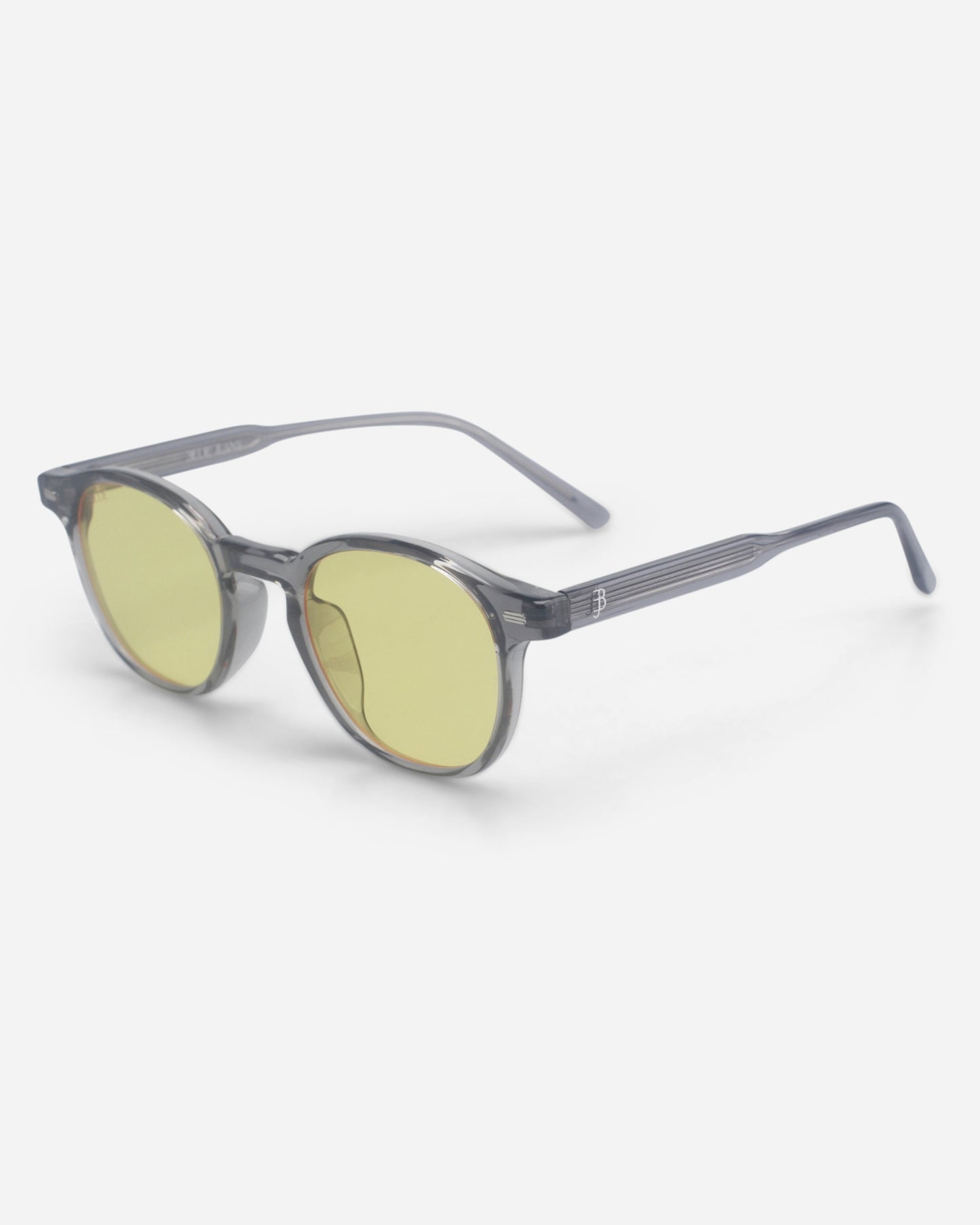 Round sunglasses with yellow lenses and gray frames on a plain background.
