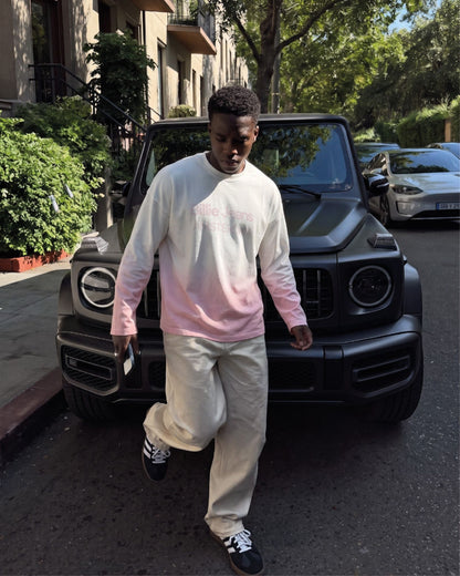Man wearing the Billie Long Sleeve Fade with beige trousers walking past a black SUV