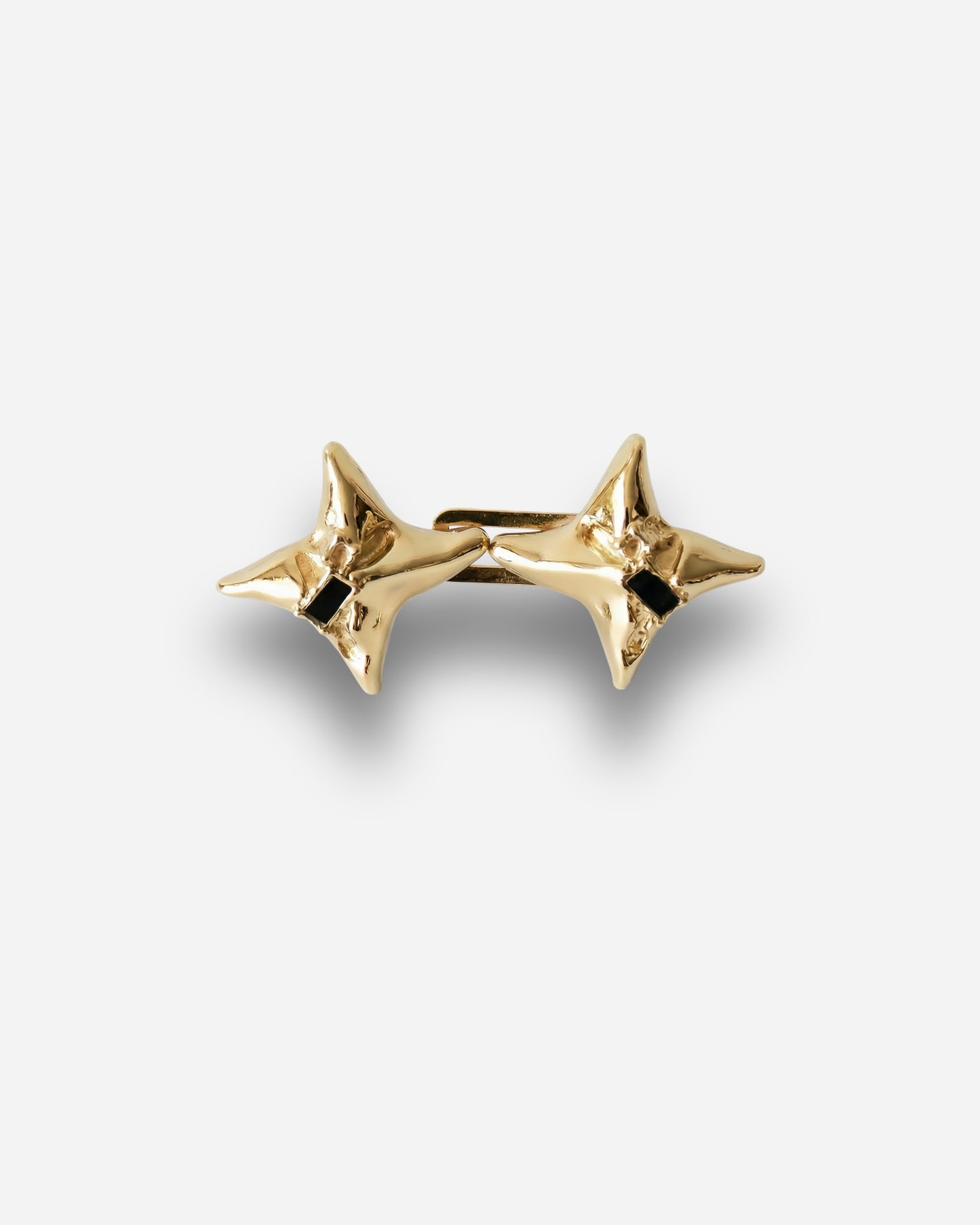 Gold star-shaped earrings with a black detail in the center.