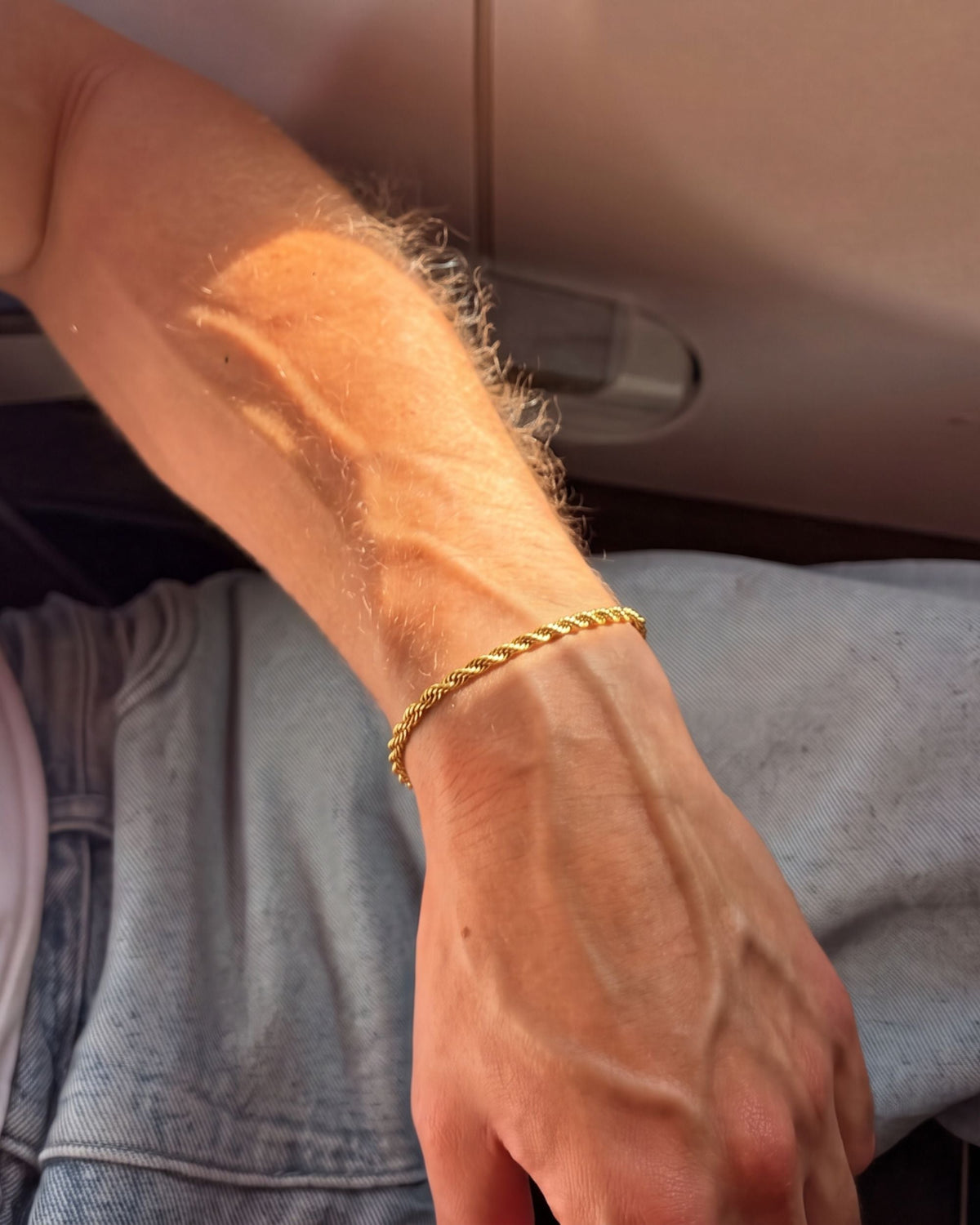 Close-up of the gold Billie Rope Bracelet 3mm on a wrist in warm sunlight