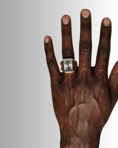 Close-up of a hand wearing a watch and a ring.