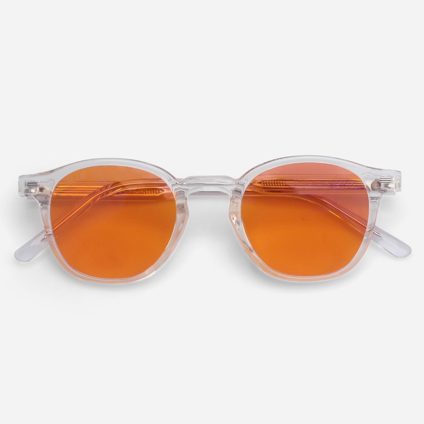 Blue light glasses with orange lenses and clear frames on a white background