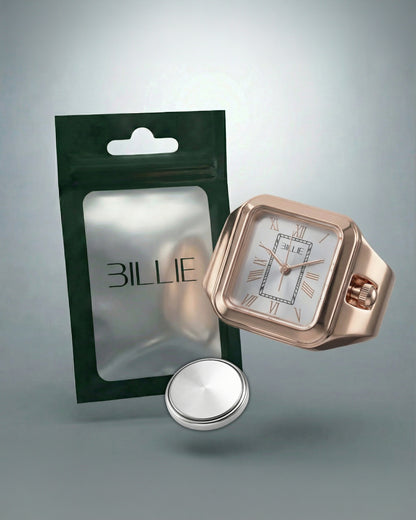 A rose gold watch next to a green packaging and a silver button battery.